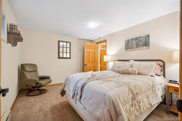 bedroom with carpet floors and a baseboard radiator