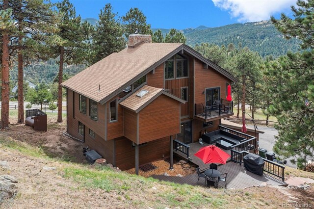 back of property with a mountain view