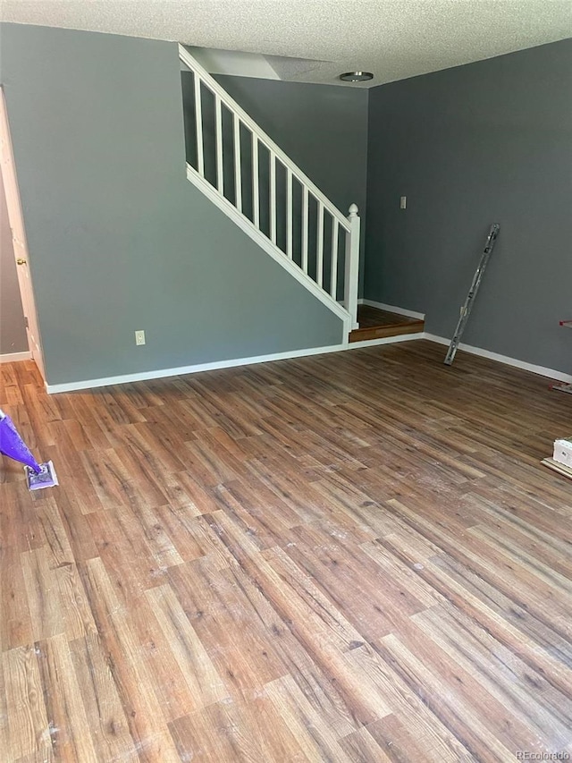 interior space featuring a textured ceiling and hardwood / wood-style flooring