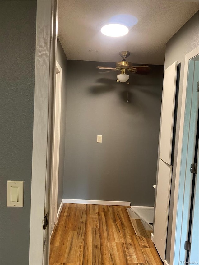677 Vrain St Unit 3, Denver, CO 80204 - hall with a textured ceiling, baseboards, and wood finished floors