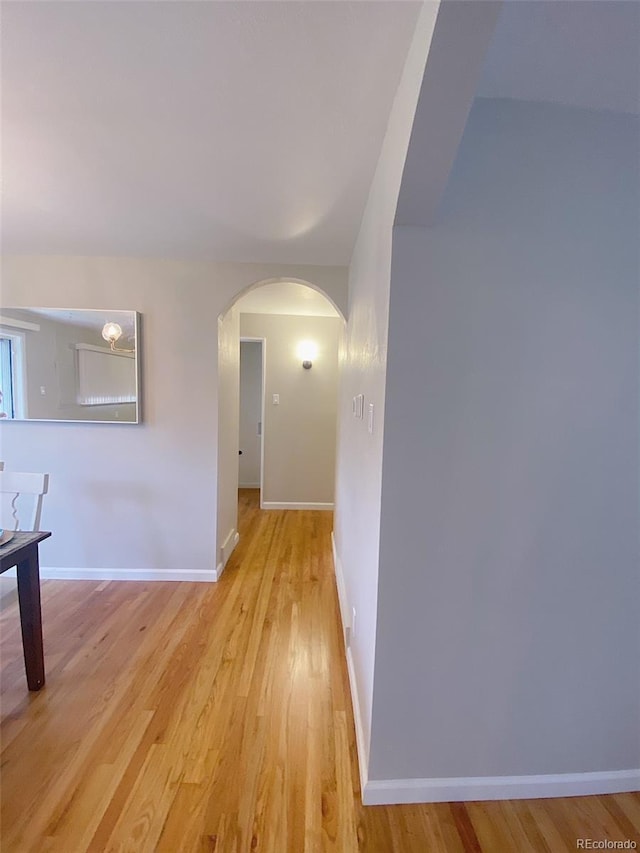 3000 Billings St, Aurora, CO 80011 - hallway featuring arched walkways, light wood-type flooring, and baseboards