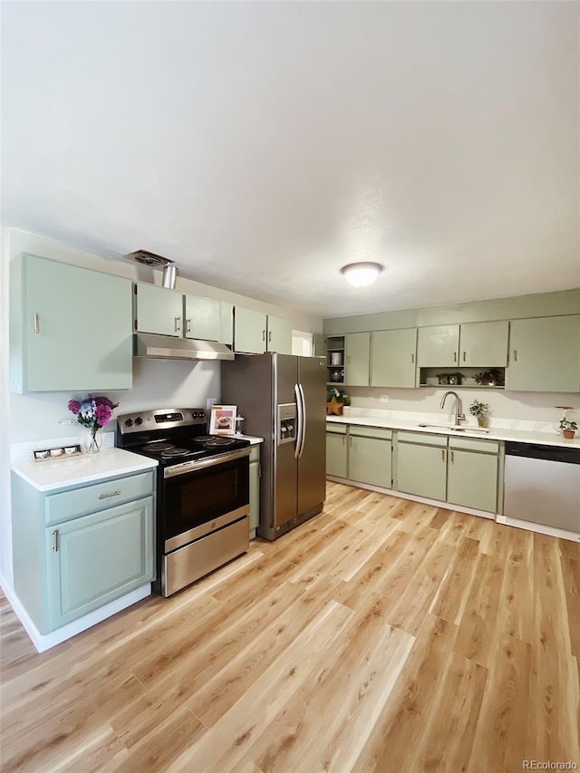 3000 Billings St, Aurora, CO 80011 - kitchen featuring stainless steel appliances, a sink, light wood-style floors, light countertops, and under cabinet range hood