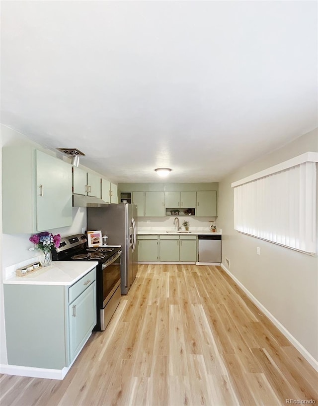 3000 Billings St, Aurora, CO 80011 - kitchen with appliances with stainless steel finishes, green cabinetry, a sink, and light countertops
