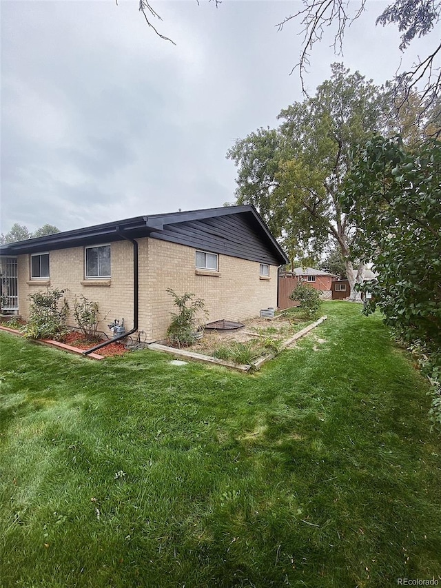 3000 Billings St, Aurora, CO 80011 - view of side of property with brick siding and a yard