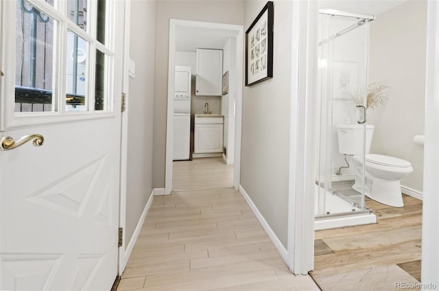 hall with sink and light hardwood / wood-style flooring