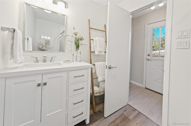 bathroom with hardwood / wood-style floors and vanity