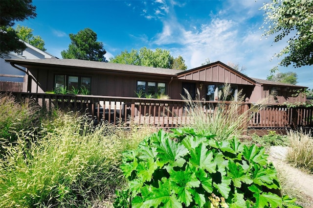 rear view of property featuring a deck