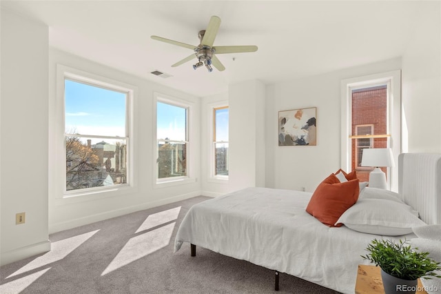 bedroom with visible vents, baseboards, carpet, and a ceiling fan