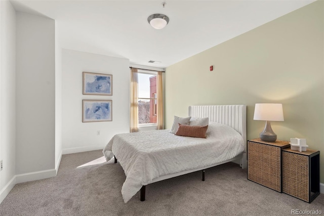 bedroom featuring carpet flooring, visible vents, and baseboards