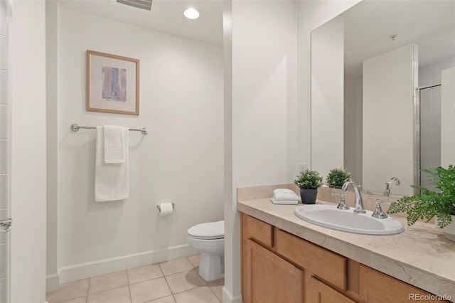 bathroom featuring tile patterned floors, toilet, vanity, and baseboards