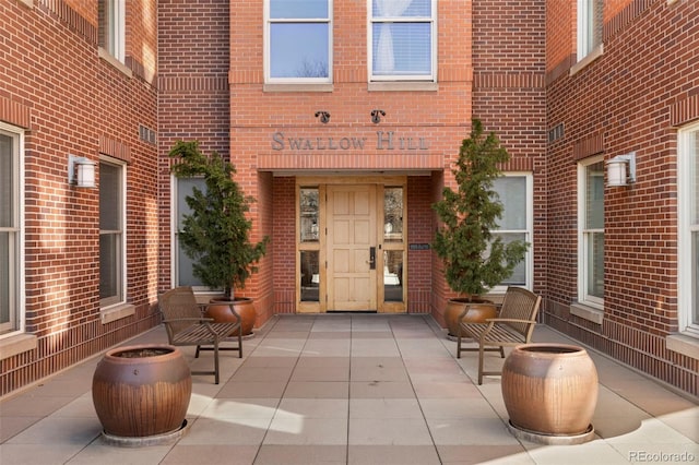 entrance to property with brick siding