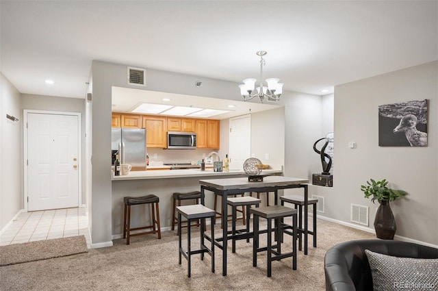 23612 Pondview Pl Unit A, Golden, CO 80401 - dining space with light colored carpet, a chandelier, and recessed lighting