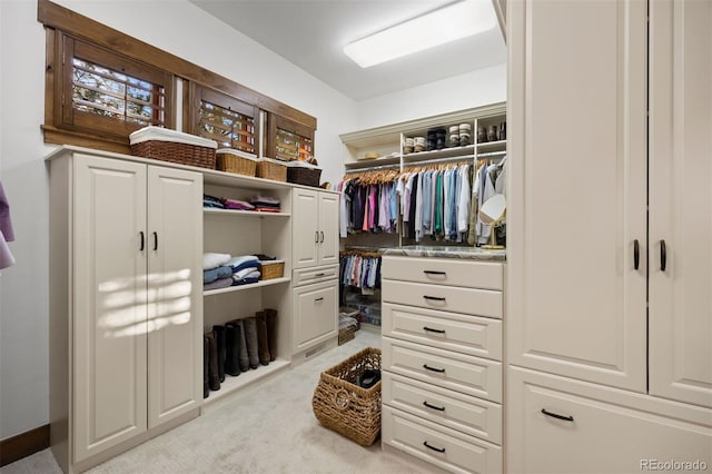 walk in closet featuring carpet flooring