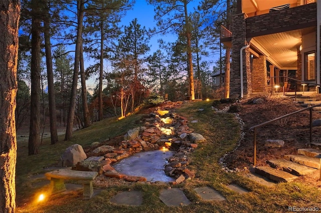 view of yard with a balcony