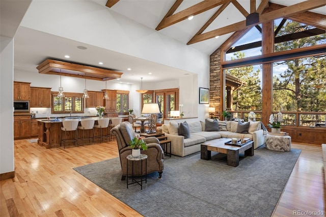 646 Ruby Trust Dr, Castle Rock, CO 80108 - living area with high vaulted ceiling, healthy amount of natural light, beam ceiling, light wood-style flooring, and recessed lighting