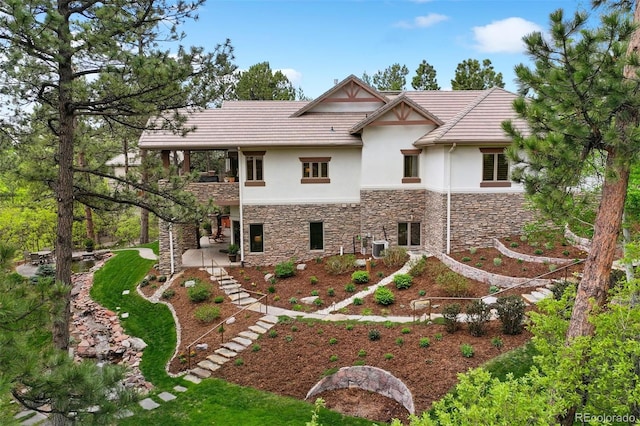 646 Ruby Trust Dr, Castle Rock, CO 80108 - rear view of property featuring stone siding, stucco siding, and stairway