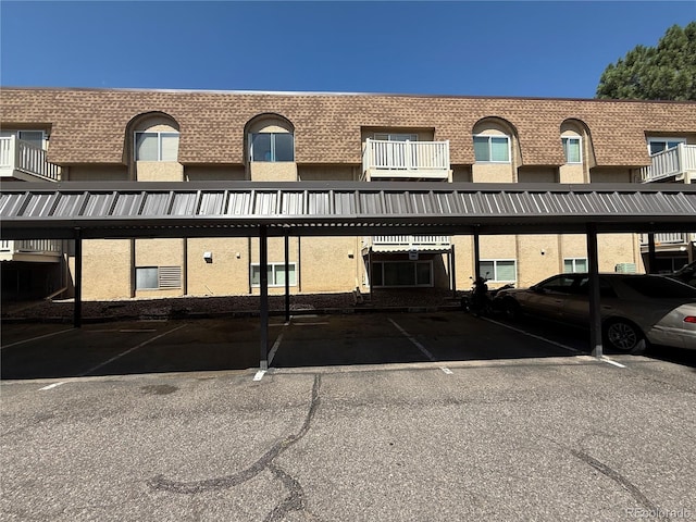 7695 E Quincy Ave Unit 207, Denver, CO 80237 - view of building exterior featuring covered parking