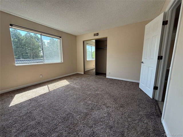 7695 E Quincy Ave Unit 207, Denver, CO 80237 - unfurnished bedroom with carpet flooring, a textured ceiling, and a closet