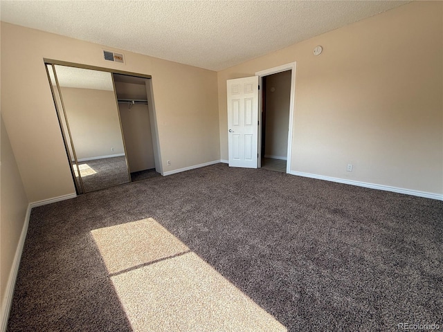 7695 E Quincy Ave Unit 207, Denver, CO 80237 - unfurnished bedroom featuring carpet, a closet, and a textured ceiling