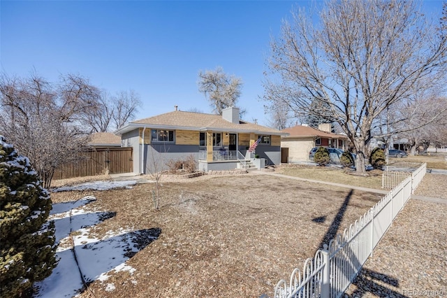 ranch-style house featuring a fenced front yard, a chimney, a gate, and a porch