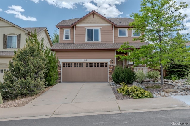 2908 Open Sky Way, Castle Rock, CO 80109 - craftsman-style home featuring an attached garage, driveway, stone siding, and roof with shingles