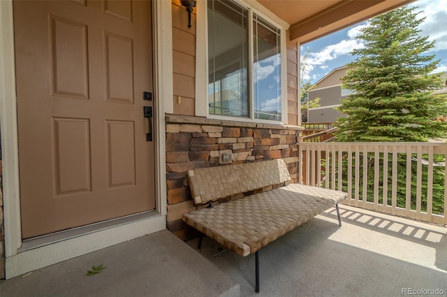 2908 Open Sky Way, Castle Rock, CO 80109 - property entrance featuring covered porch and stone siding