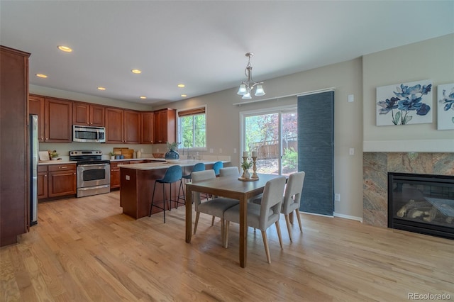 2908 Open Sky Way, Castle Rock, CO 80109 - dining space with light wood-style floors, recessed lighting, and a fireplace