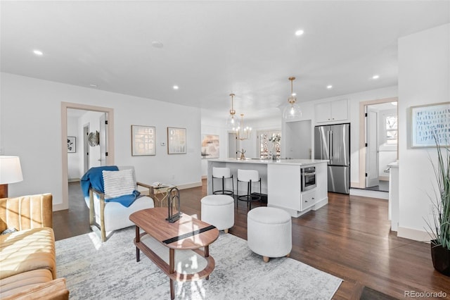 living room featuring dark hardwood / wood-style flooring and a notable chandelier