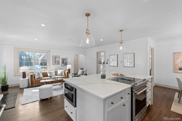 kitchen with electric stove, white cabinetry, light stone countertops, dark hardwood / wood-style flooring, and decorative light fixtures