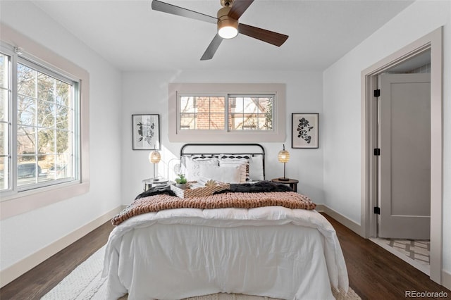 bedroom with dark hardwood / wood-style flooring and ceiling fan