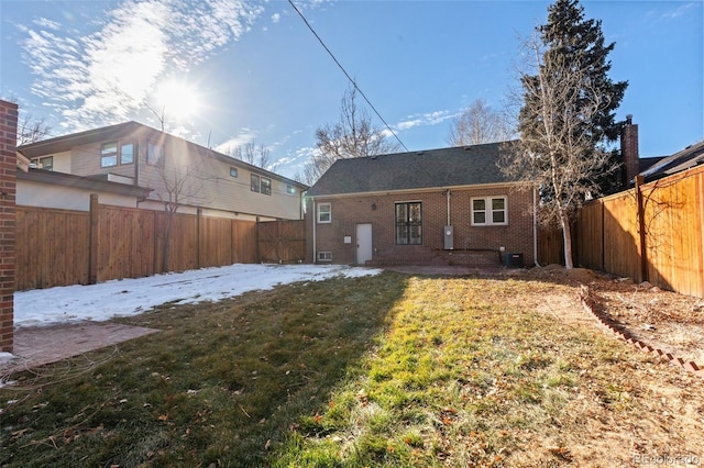 rear view of property with a lawn