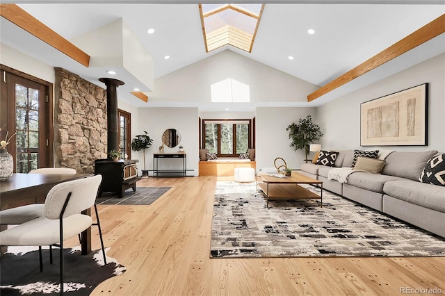 8782 S Ault Ln, Morrison, CO 80465 - living room featuring a wood stove, plenty of natural light, hardwood / wood-style flooring, recessed lighting, and high vaulted ceiling
