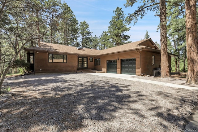 8782 S Ault Ln, Morrison, CO 80465 - view of front of property with french doors, an attached garage, and driveway