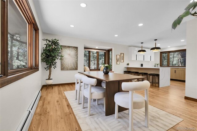 8782 S Ault Ln, Morrison, CO 80465 - dining area featuring a baseboard radiator, light wood finished floors, recessed lighting, and baseboards