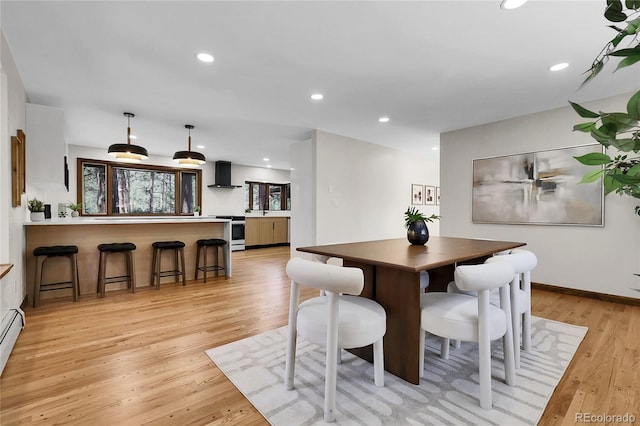 8782 S Ault Ln, Morrison, CO 80465 - dining area with light wood-style flooring, recessed lighting, baseboard heating, and baseboards