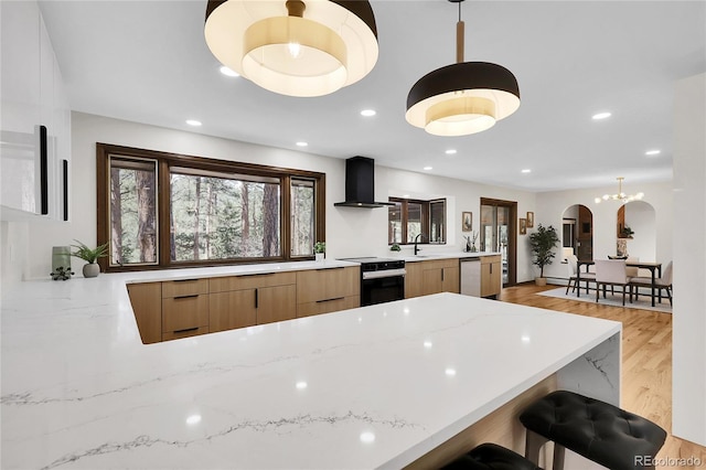 8782 S Ault Ln, Morrison, CO 80465 - kitchen with wall chimney exhaust hood, dishwasher, range with electric stovetop, modern cabinets, and arched walkways