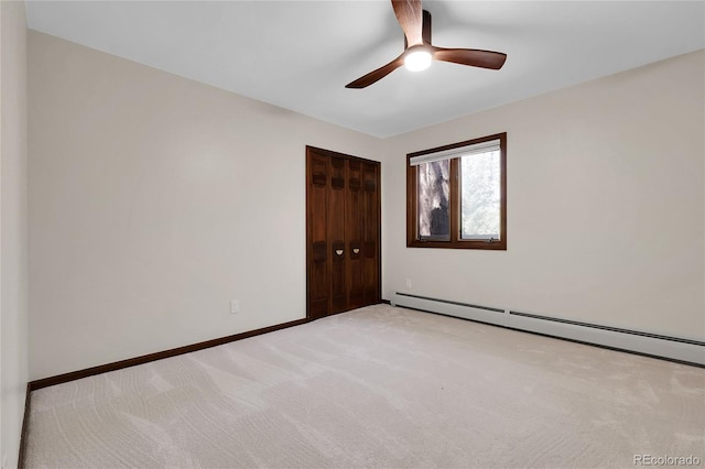 8782 S Ault Ln, Morrison, CO 80465 - unfurnished bedroom with a baseboard heating unit, light colored carpet, a closet, and baseboards