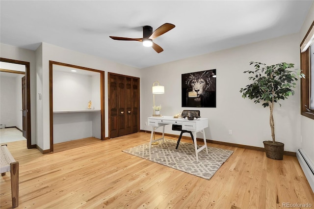 8782 S Ault Ln, Morrison, CO 80465 - office area with baseboard heating, a ceiling fan, light wood finished floors, and baseboards