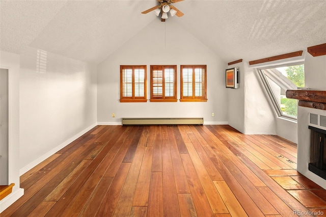 17053 E Jamison Ave, Centennial, CO 80016 - unfurnished living room featuring a baseboard radiator, hardwood / wood-style floors, a ceiling fan, lofted ceiling, and a textured ceiling