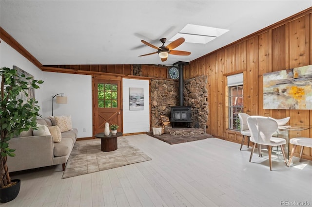 41 Silver Spruce, Boulder, CO 80302 - living room with wood walls, ceiling fan, a skylight, a wood stove, and baseboards