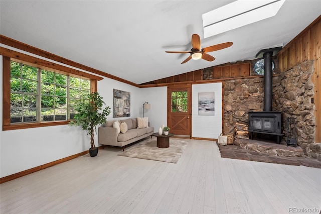 41 Silver Spruce, Boulder, CO 80302 - living room with lofted ceiling, a wood stove, hardwood / wood-style flooring, a ceiling fan, and baseboards