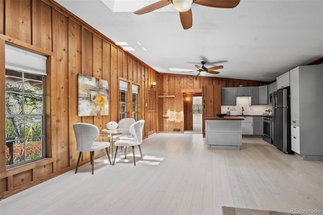 41 Silver Spruce, Boulder, CO 80302 - kitchen featuring freestanding refrigerator, ceiling fan, a sink, vaulted ceiling, and wood walls