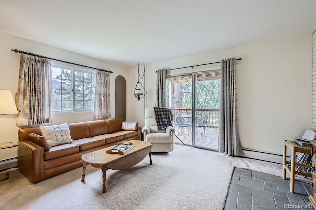 living room with a baseboard heating unit and carpet flooring