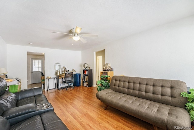 living room featuring hardwood / wood-style floors and ceiling fan