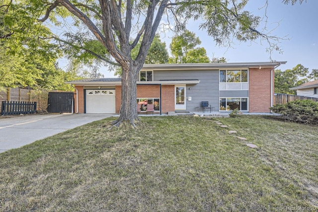 view of front of property featuring a garage and a front lawn