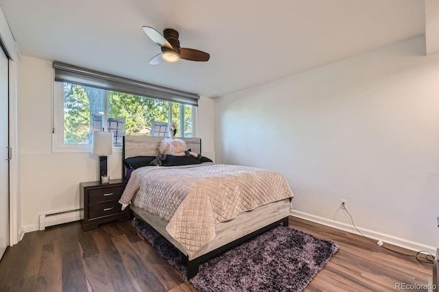 bedroom featuring baseboard heating, ceiling fan, and dark hardwood / wood-style floors