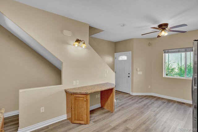 foyer with light hardwood / wood-style floors and ceiling fan