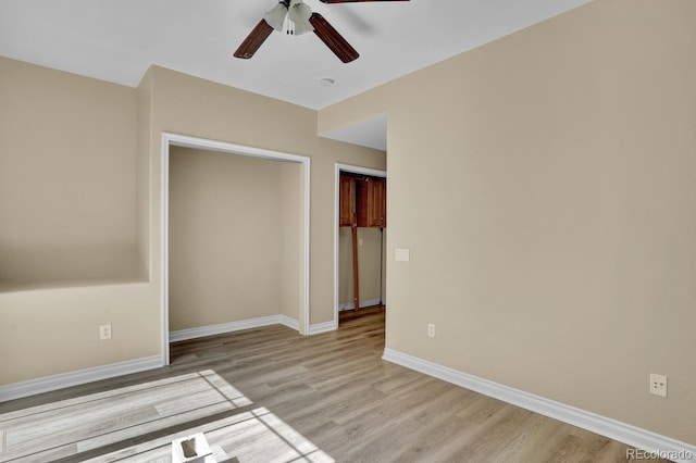 unfurnished bedroom featuring a closet, light wood-type flooring, and ceiling fan