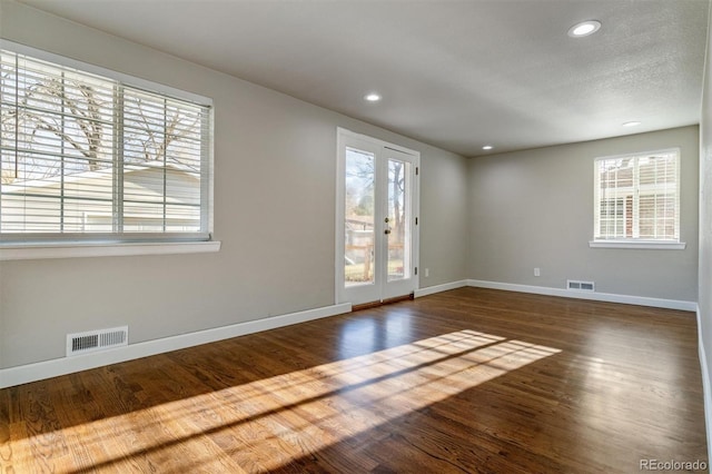 5500 Holland Dr, Arvada, CO 80002 - spare room featuring baseboards, healthy amount of natural light, dark wood-style floors, and recessed lighting