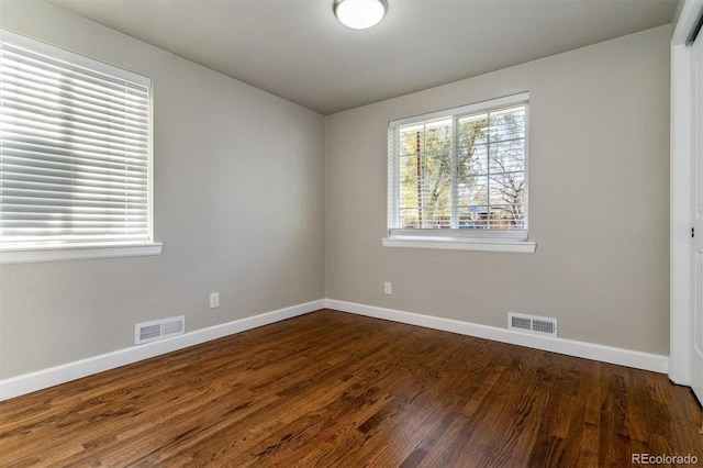 5500 Holland Dr, Arvada, CO 80002 - unfurnished room with baseboards and dark wood-style flooring